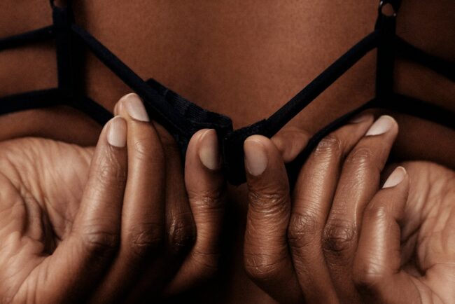 person holding black brassiere strap