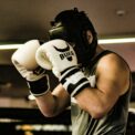 a man wearing a white and black boxing glove