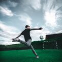 man playing soccer during daytime
