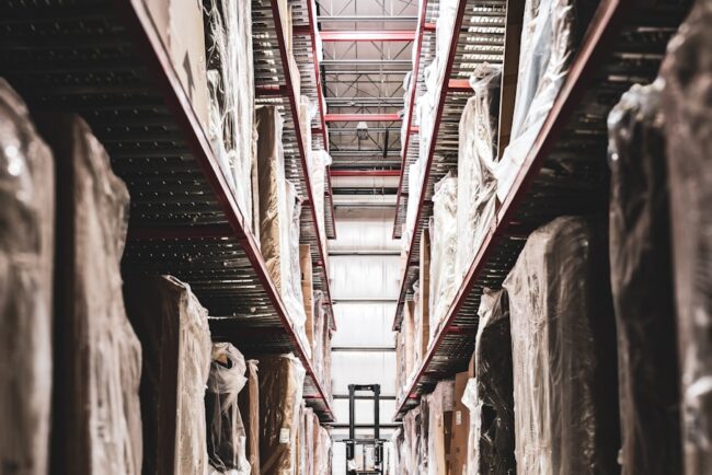 A train track in a large building with statues on it