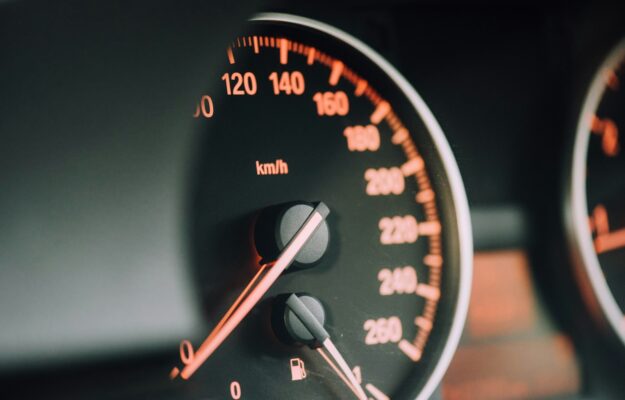closeup photo of black analog speedometer