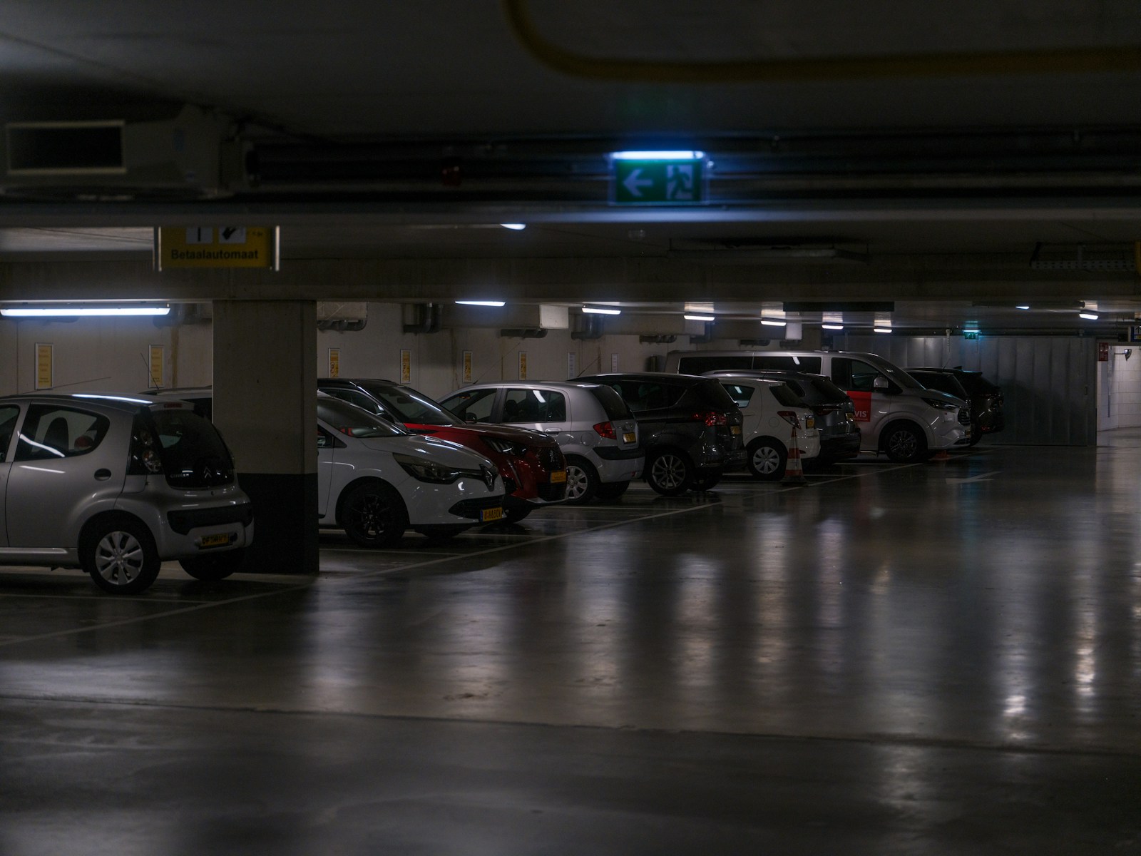 Cars parked in a dimly lit underground garage.