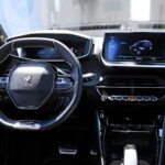 the interior of a car with a steering wheel and dashboard
